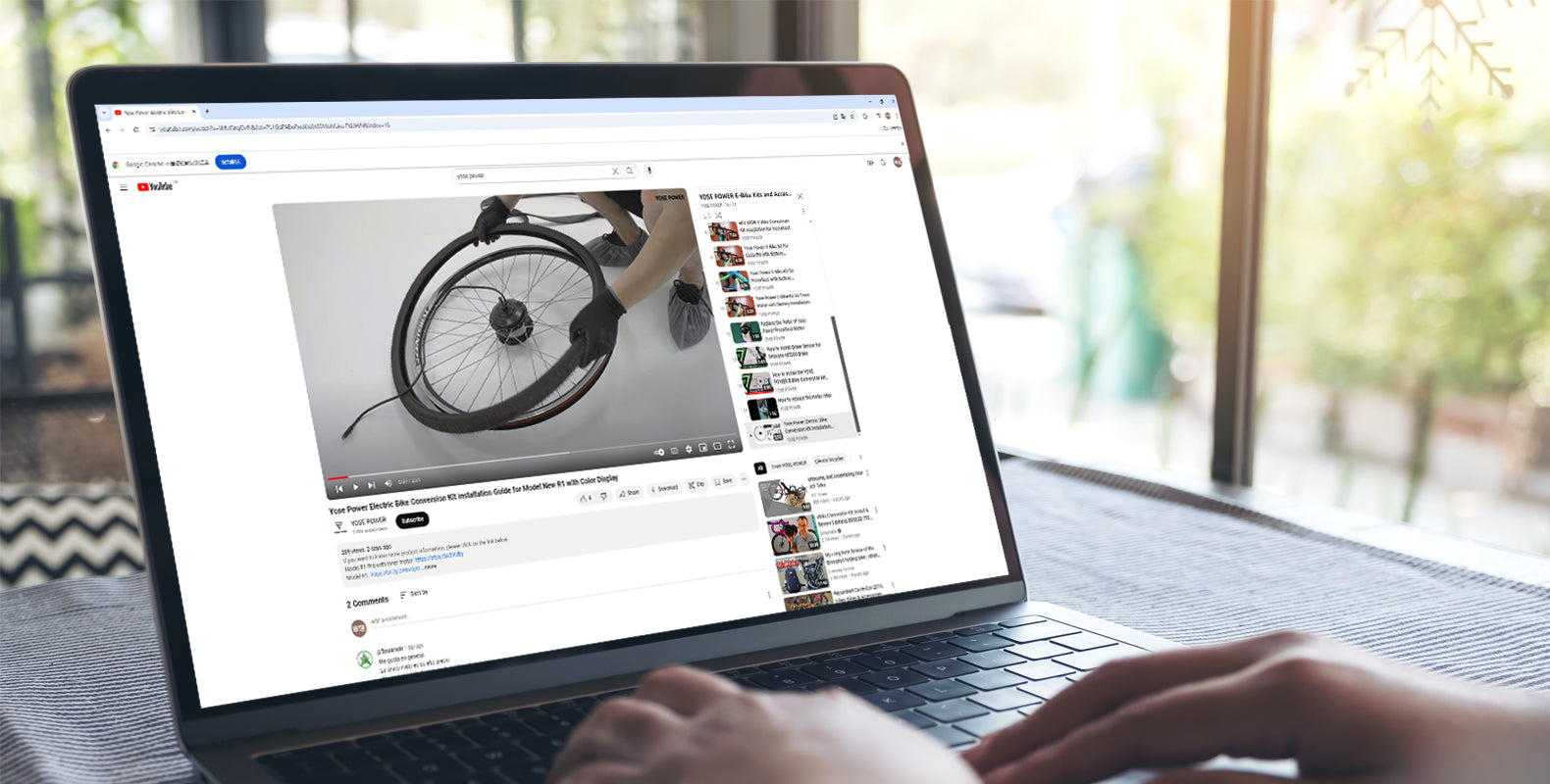 Laptop screen displaying a YouTube tutorial video for YOSE POWER e-bike conversion kit installation.