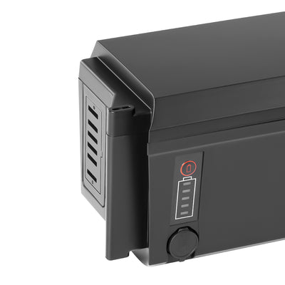 Close-up of the k e-bike battery (Model EBB-048116-SF06S), featuring a battery level indicator with a red activation button, a protective rubber cap over the charge port